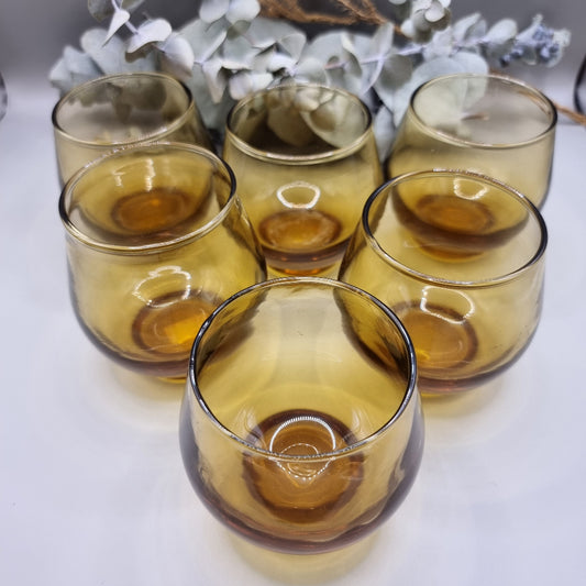 Set of 6 rounded amber glass tumblers, perfect for wine, cocktails, or display.