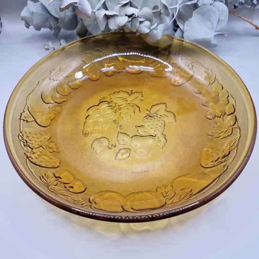 Amber glass serving dish with embossed fruit detail, made in Indonesia.