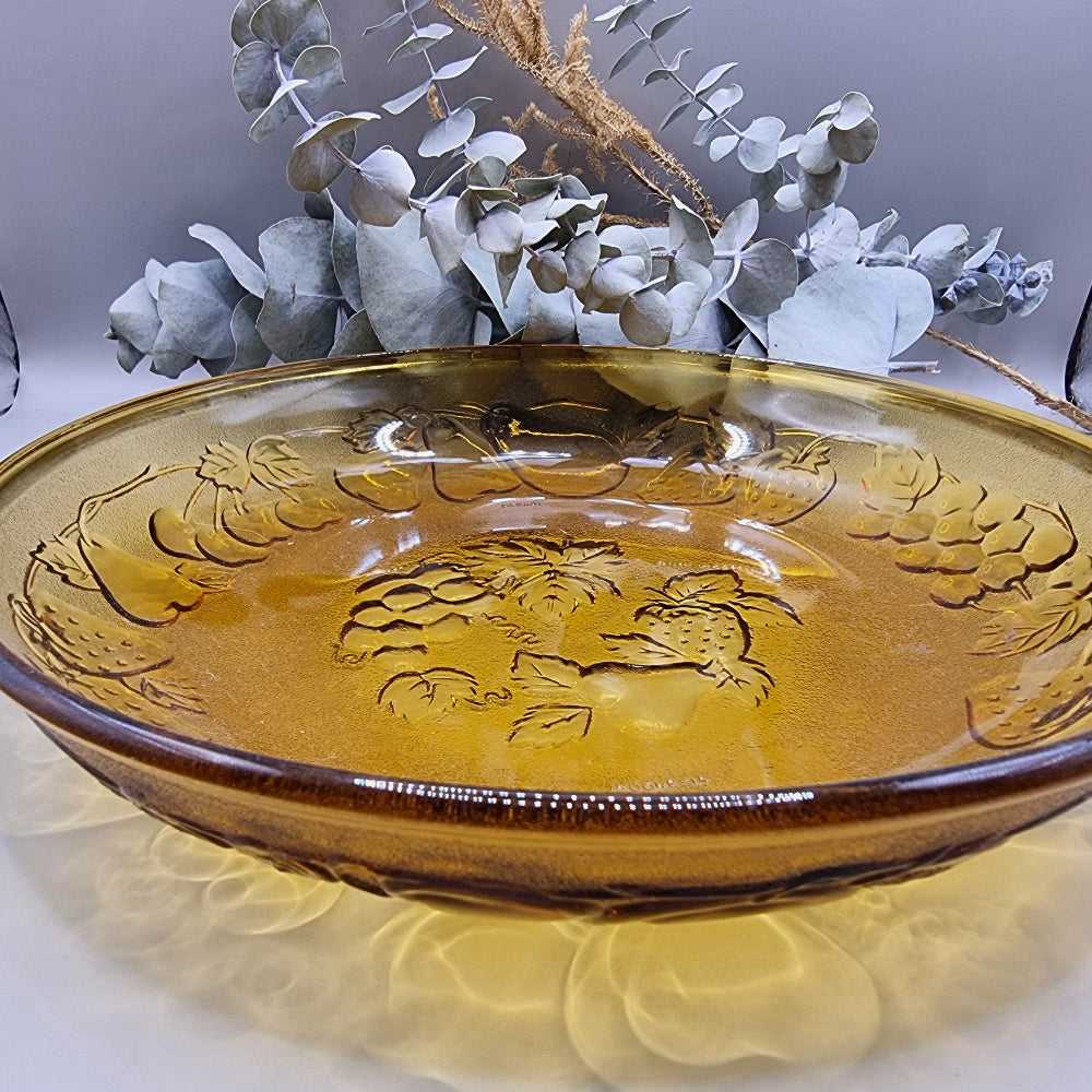 Amber glass serving dish with embossed fruit detail, made in Indonesia.