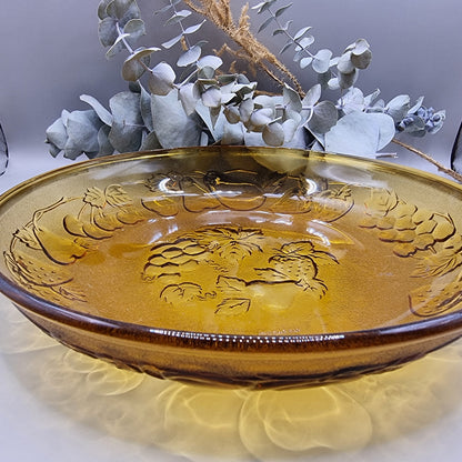 Amber glass serving dish with embossed fruit detail, made in Indonesia.