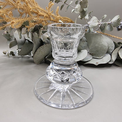 Clear cut crystal taper candle holder with starburst base and geometric cross-cut stem.