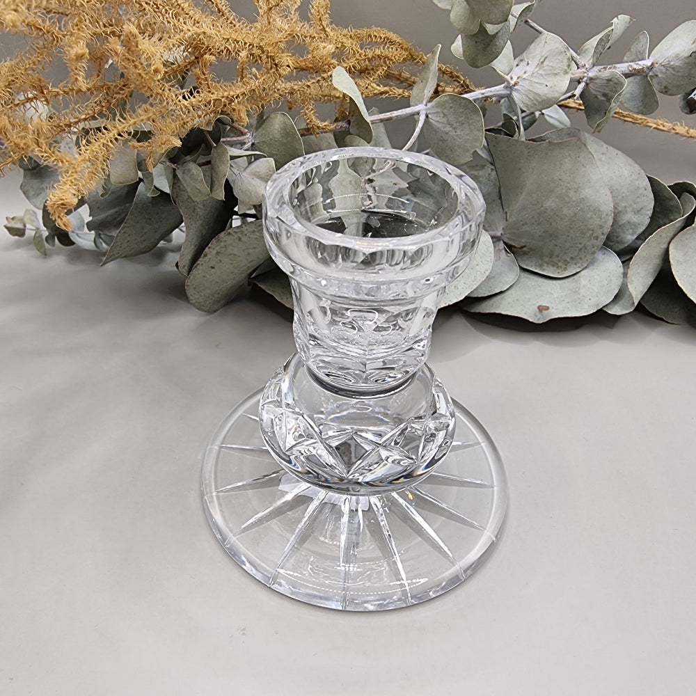 Clear cut crystal taper candle holder with starburst base and geometric cross-cut stem.