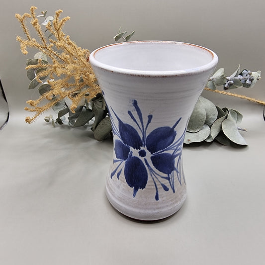 Handcrafted ceramic vase with cobalt blue flower design on off-white glaze.