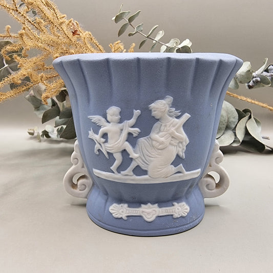 Blue vase with white cherub and woman playing lute in raised relief, Japanese jasperware style.