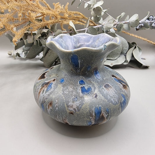 Ruffled rim ceramic vase with blue and earthy glaze, small chip on rim.