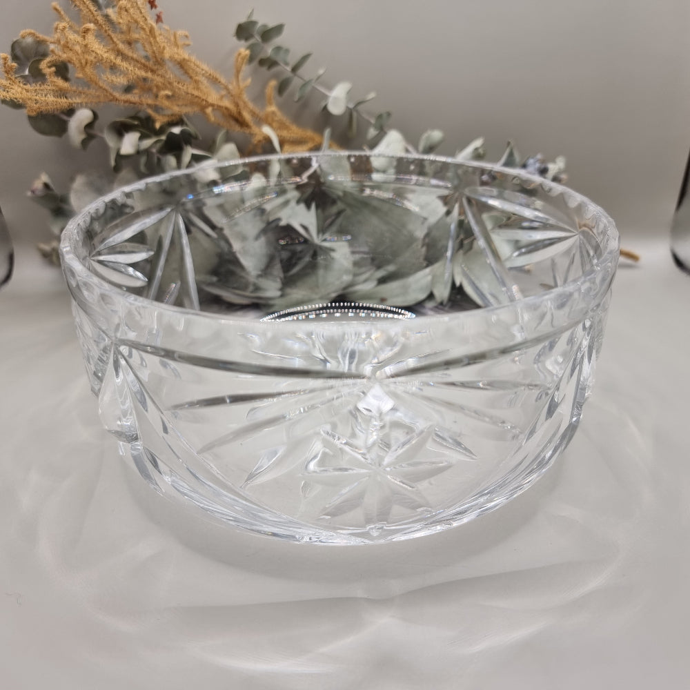 Pressed glass bowl with deep starburst and fan-cut pattern.