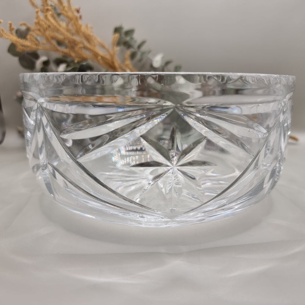 Pressed glass bowl with deep starburst and fan-cut pattern.