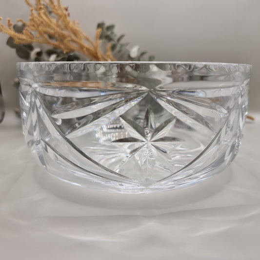 Pressed glass bowl with deep starburst and fan-cut pattern.