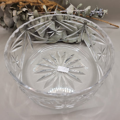Pressed glass bowl with deep starburst and fan-cut pattern.