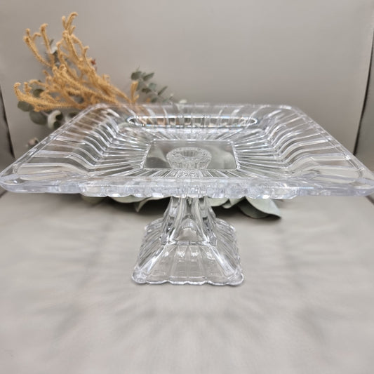 Clear square glass pedestal dish with ribbed edges and raised base