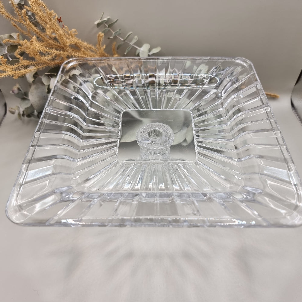Clear square glass pedestal dish with ribbed edges and raised base