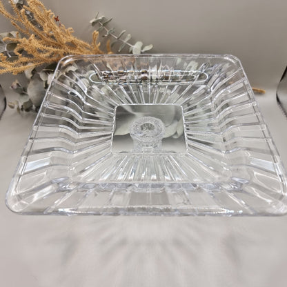 Clear square glass pedestal dish with ribbed edges and raised base