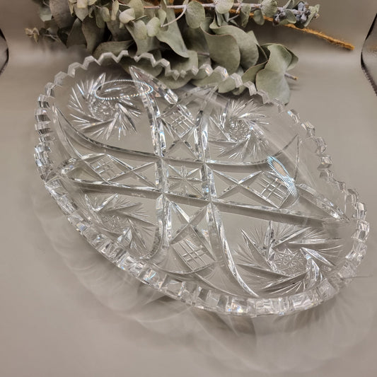 Oval cut glass tray with scalloped edge and intricate pressed pattern