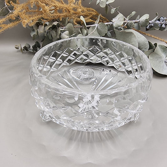 Small footed pressed glass bowl with diamond pattern and scroll feet.