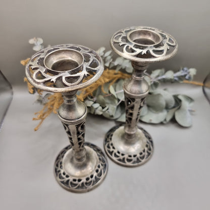 Pair of vintage filigree candle holders with ornate cut-out design
