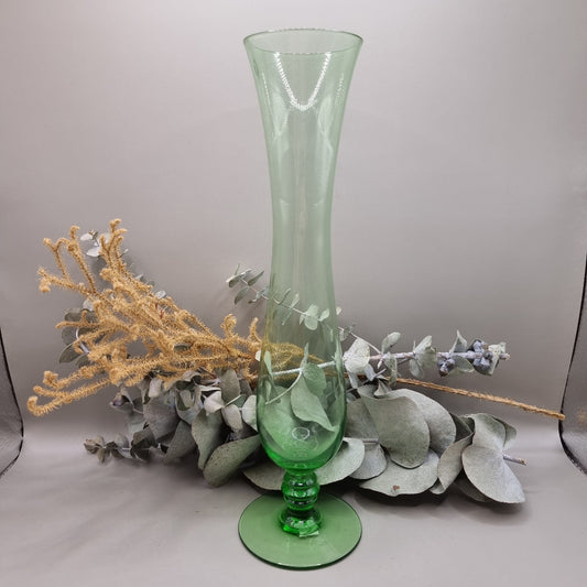 Tall vintage green glass vase with pedestal base and flared top