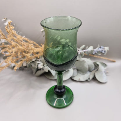 Vintage dark green handblown wine glass with flared rim and bubbled texture