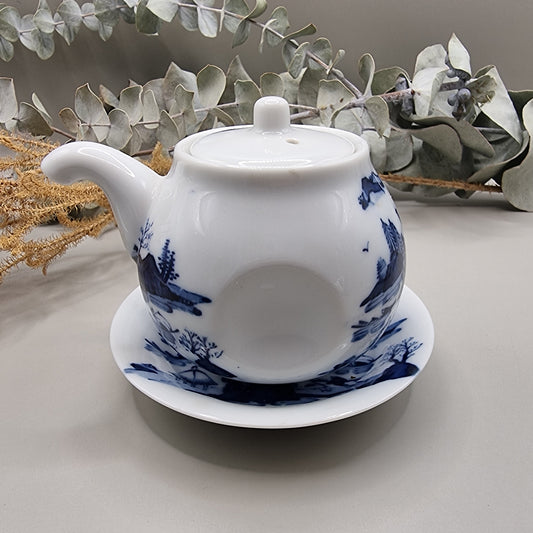 Japanese blue and white sake pot with lid and matching saucer featuring Hill & Water landscape design