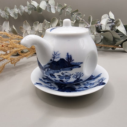 Japanese blue and white sake pot with lid and matching saucer featuring Hill & Water landscape design