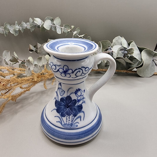Blue and white ceramic candle holder with handle and floral design, handcrafted in Thailand.