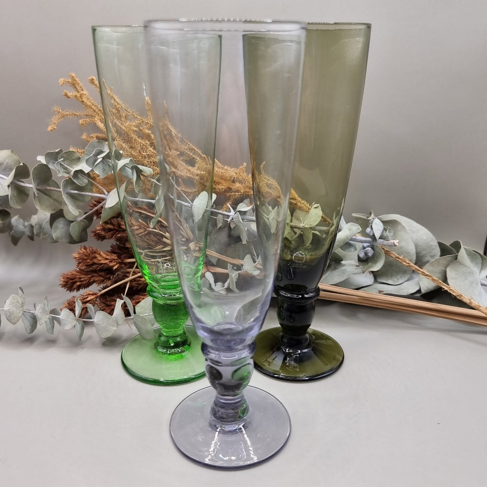 Set of 4 tall coloured glass flutes in green, grey, purple, and olive.

