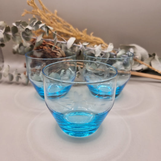 Set of 3 aqua blue glass tumblers with etched floral design.