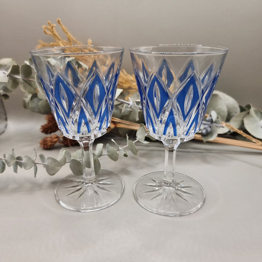 Pair of cobalt blue cut crystal wine glasses with diamond pattern and starburst base.