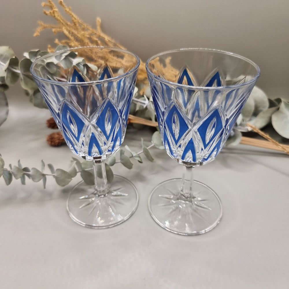 Pair of cobalt blue cut crystal wine glasses with diamond pattern and starburst base.