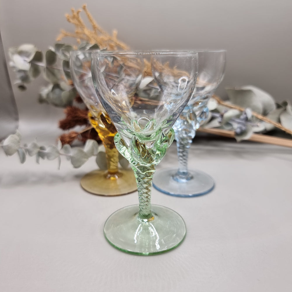 Set of 3 coloured liqueur glasses with twisted stems in blue, green, and amber.