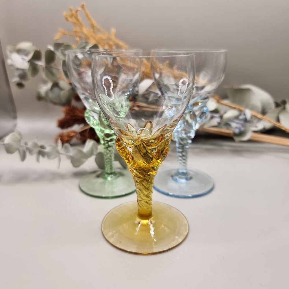 Set of 3 coloured liqueur glasses with twisted stems in blue, green, and amber.