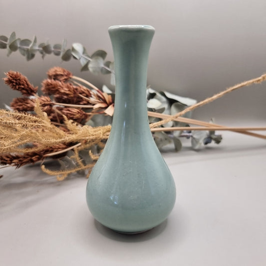 Light blue Korean pottery bud vase with narrow neck and rounded base.
