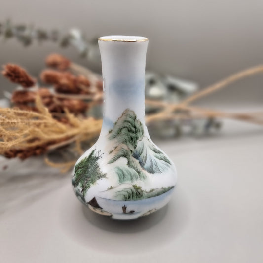 Hand-painted Chinese porcelain bud vase with mountain scene and calligraphy.