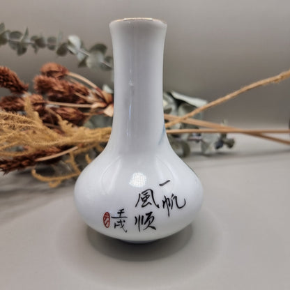 Hand-painted Chinese porcelain bud vase with mountain scene and calligraphy.