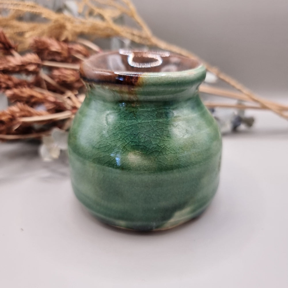 Handmade green pottery pot with crackle glaze and brown rim