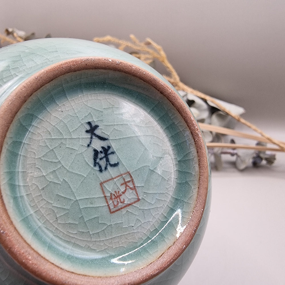 Celadon crackle glaze vase with crane and bamboo design in soft jade-green