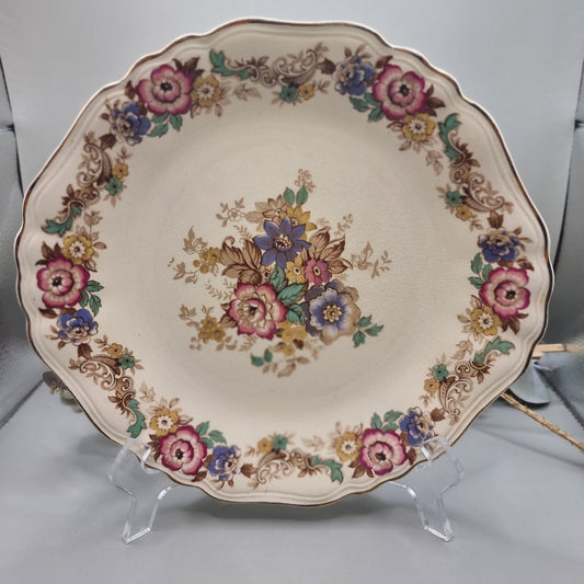 J&G Meakin Sunshine plate with scalloped edge and floral bouquet in pink, purple, yellow and green.