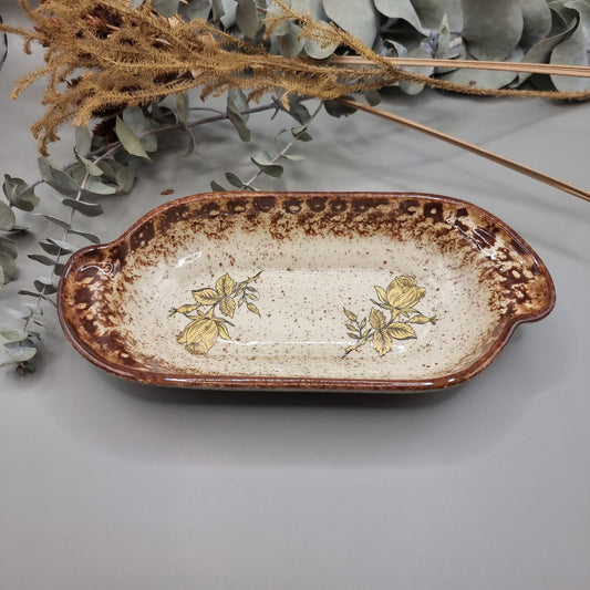 Rectangular speckled stoneware dish with brown glaze and yellow rose floral decals.