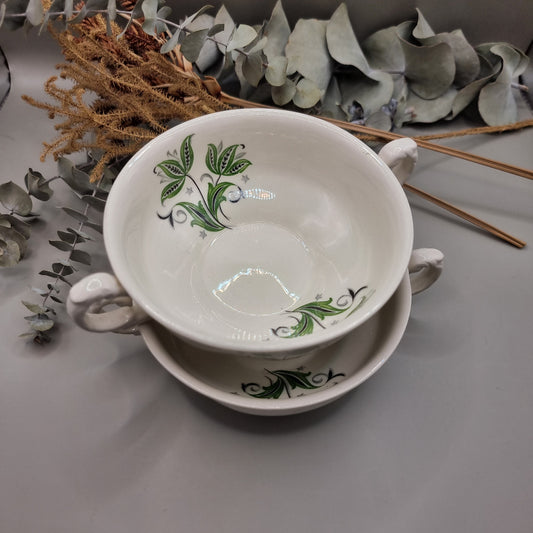 Set of two white ceramic soup bowls with green floral leaf design and twin handles