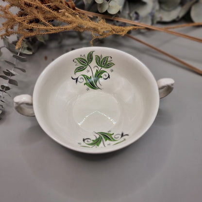 Set of two white ceramic soup bowls with green floral leaf design and twin handles