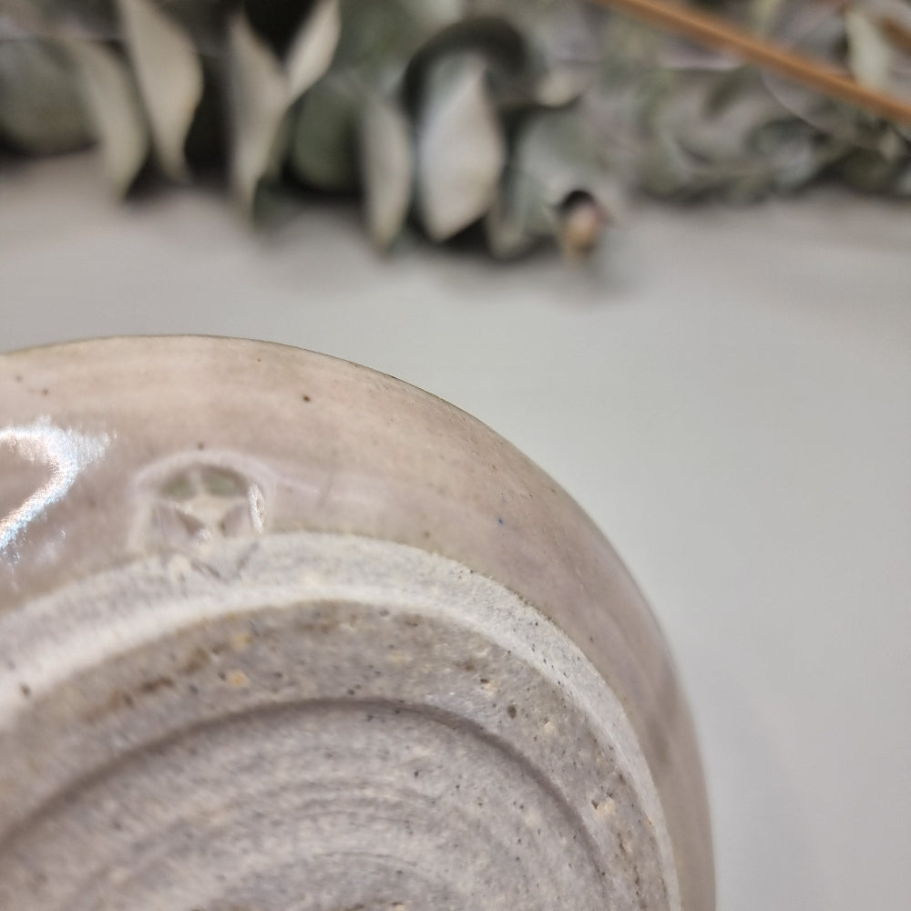 Handmade ceramic candle holder with cream glaze and green rim