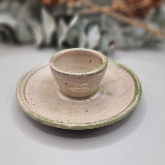 Handmade ceramic candle holder with cream glaze and green rim