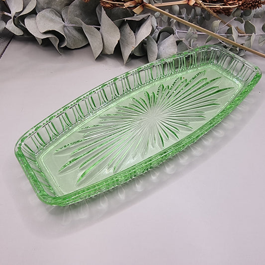 Vintage green pressed glass tray with starburst pattern and ribbed edge