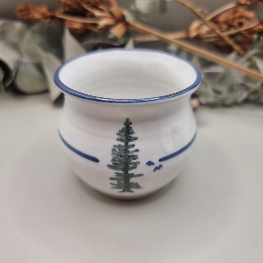 Norfolk Island pottery cup with pine tree design and blue rim