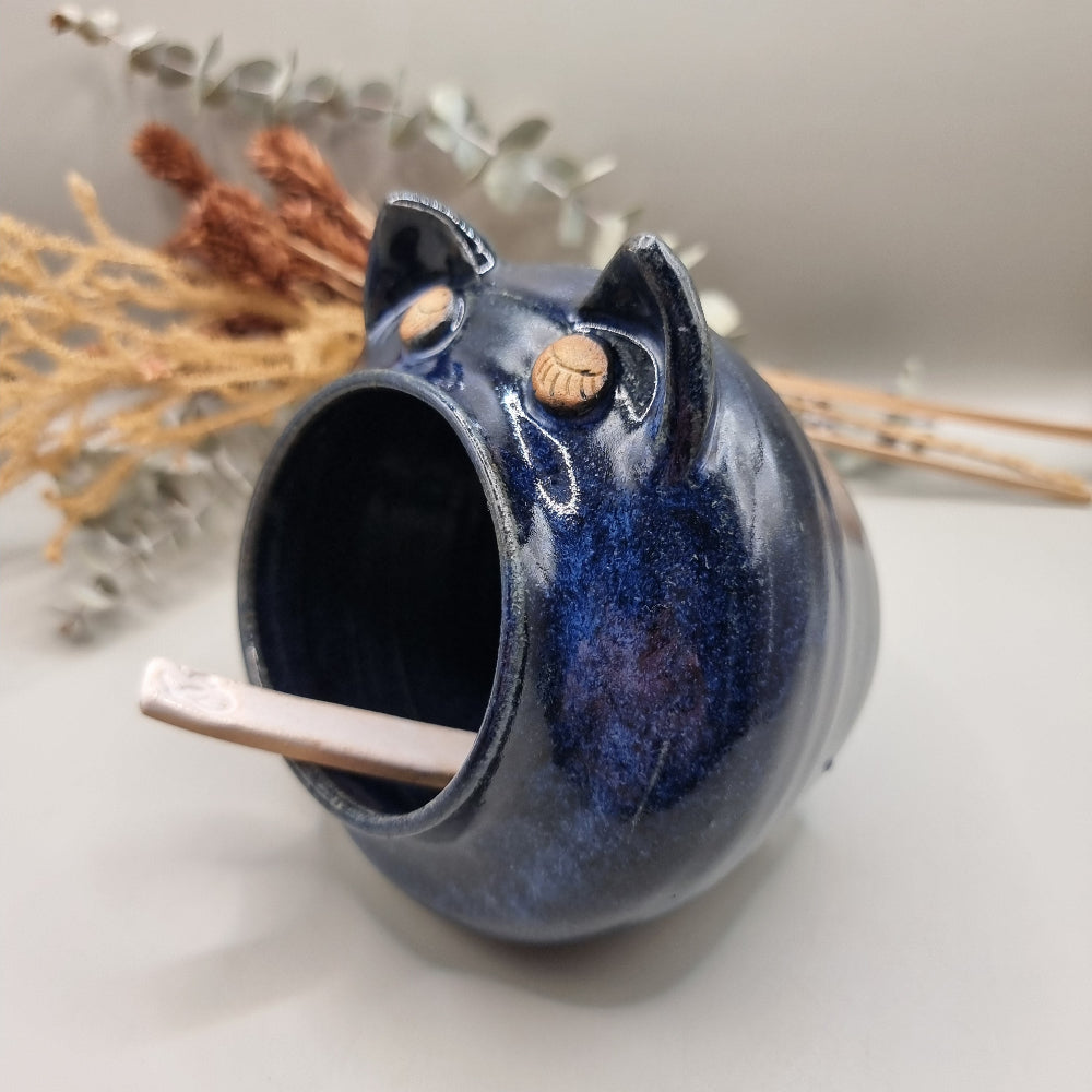 Ceramic salt pig with blue glaze and a spoon for easy seasoning