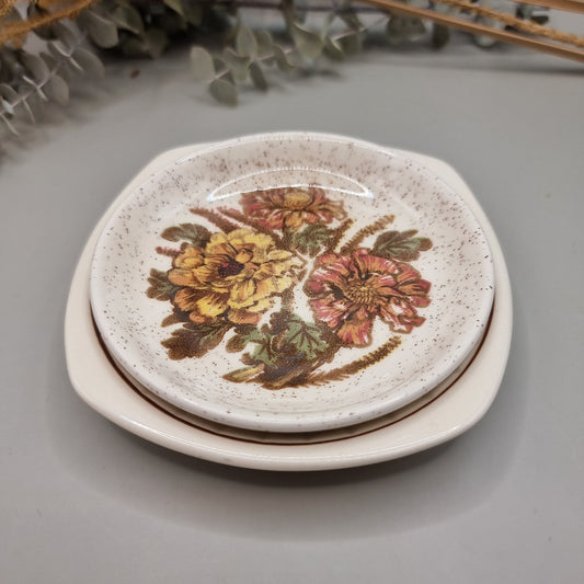 Pair of Palissy dishes with floral designs – one speckled glaze, one Springtime blossom pattern.