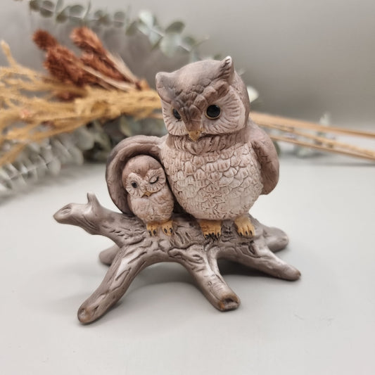 Ceramic ornament of a parent owl and baby owl perched on a branch.