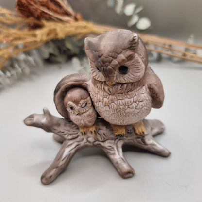 Ceramic ornament of a parent owl and baby owl perched on a branch.