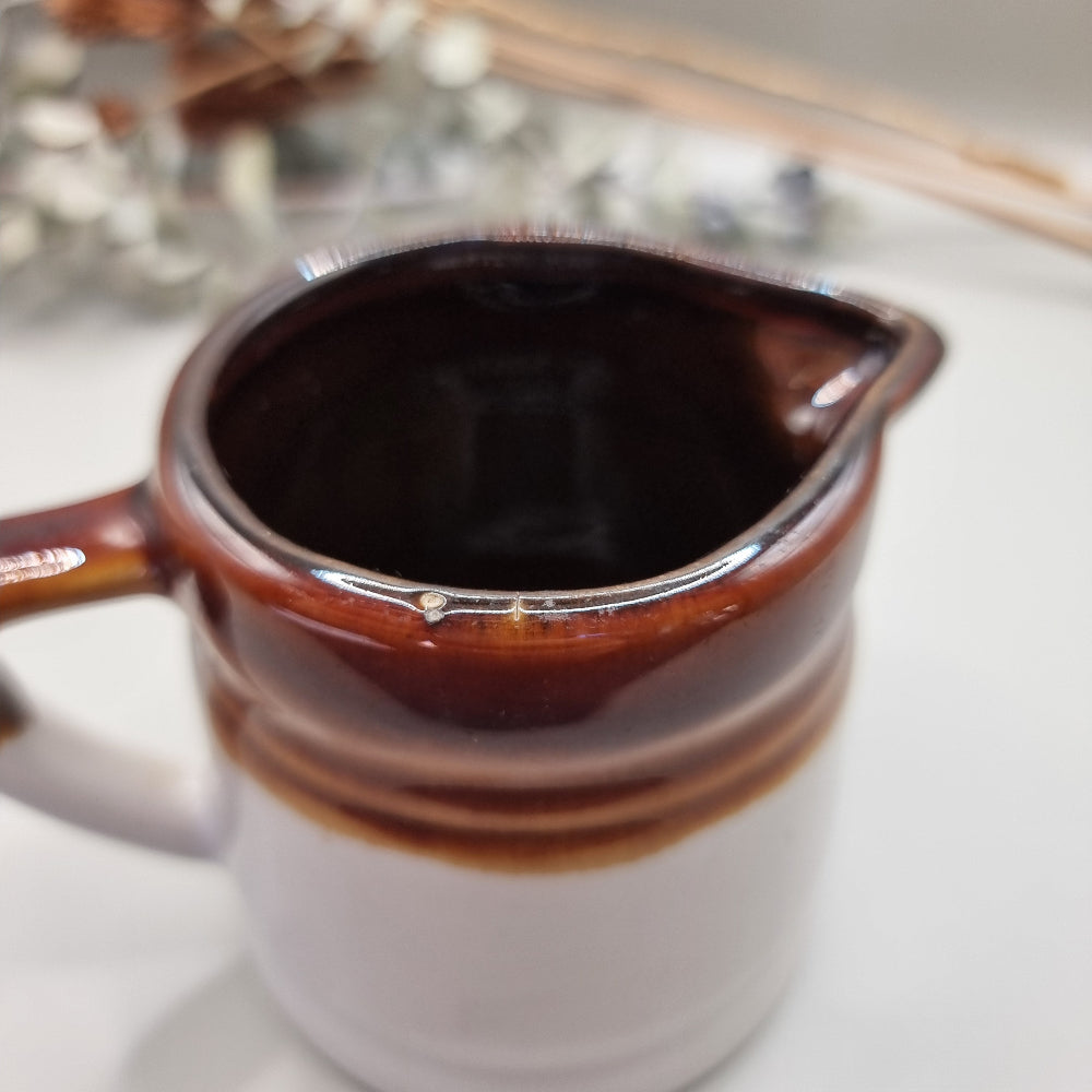 Vintage brown drip glaze stoneware measuring jugs set, marked ½ and ¼ cup.