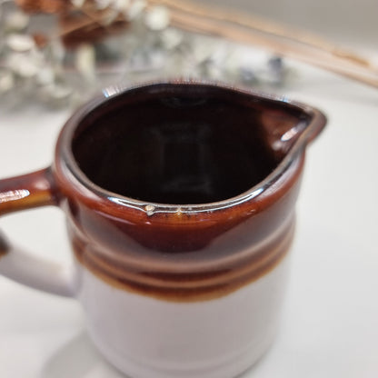 Vintage brown drip glaze stoneware measuring jugs set, marked ½ and ¼ cup.