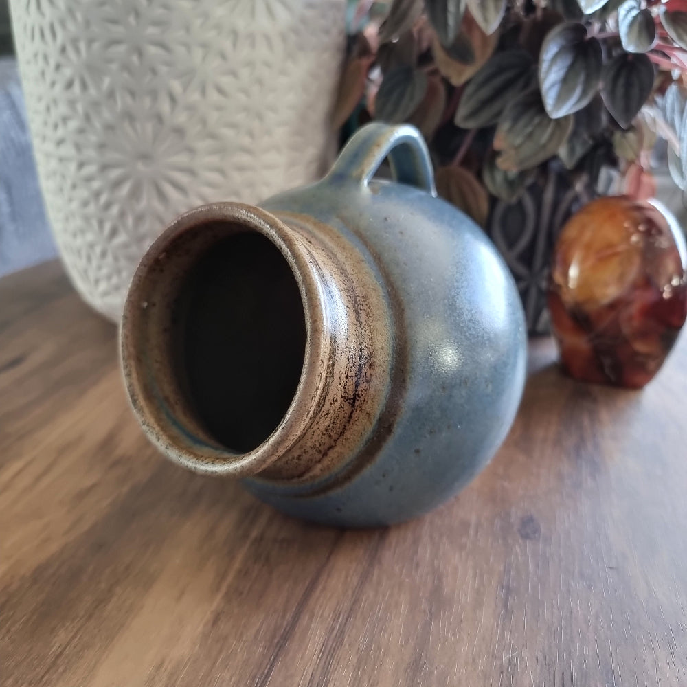 Vintage stoneware salt pig with blue-brown glaze and side handle, perfect for storing flaky sea salt